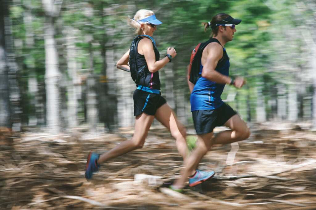 Man Woman Running Fast Through Forest