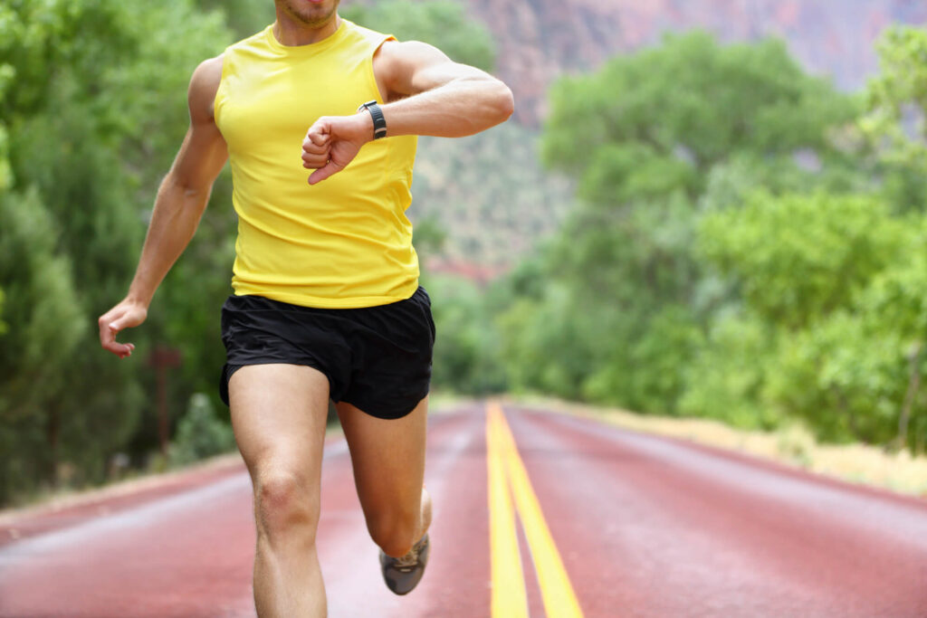 Runner Checking Speed on Watch to Run Faster